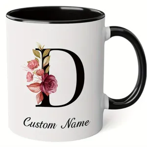 Detail shot of custom ceramic mug featuring elegant floral letter D and personalized name.