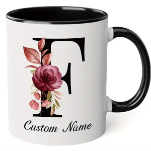 Close-up of customized ceramic mug with elegant floral letter F and personalized text.