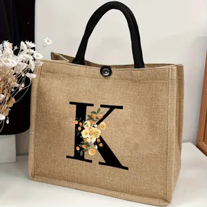 Large capacity jute tote bag featuring stylish floral letter K print for travel and beach.