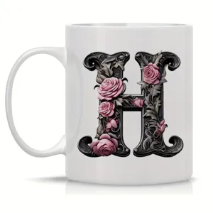 Ceramic coffee mug with floral gothic letter H design, perfect for office and daily use.
