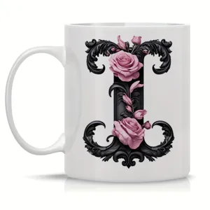 Ceramic coffee mug with elegant black initial letter and roses floral design detail.