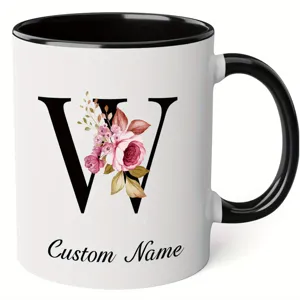 Detailed view of custom name ceramic coffee mug with watercolor floral letter W design.