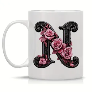 White ceramic coffee mug featuring an elegant vintage letter N and pink roses design.