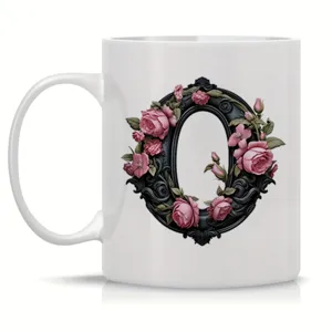 White ceramic coffee mug featuring an elegant black floral frame letter O design for office use.