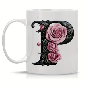 Close-up view of the white ceramic coffee mug featuring an ornate black letter P and pink roses.