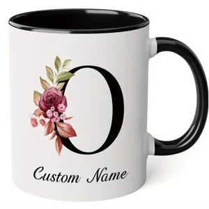 Ceramic coffee mug with custom floral letter O design, black handle and rim, perfect office gift.