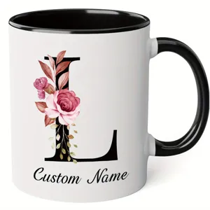 Custom letter floral ceramic coffee mug with black handle and rim, personalized monogram.
