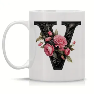 White ceramic coffee mug featuring an elegant floral black letter V design for office use.