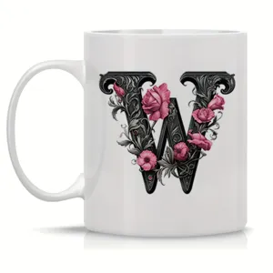 Detailed view of white ceramic coffee mug featuring elegant gothic letter W floral design.
