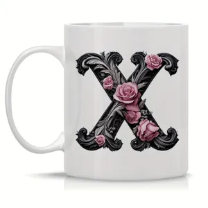 Detailed view of white ceramic coffee mug featuring elegant baroque letter X and rose design.