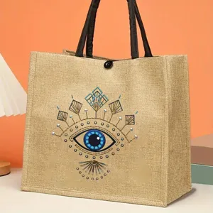 Large capacity jute tote bag with stylish evil eye print, retro canvas handbag for women daily use.