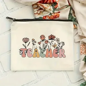 Detailed shot of canvas makeup bag with floral teacher letter print, neat zipper and texture.
