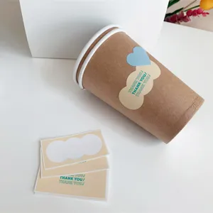 Detail view of ins-style thank you sealing stickers applied on a paper cup and sticker sheet.