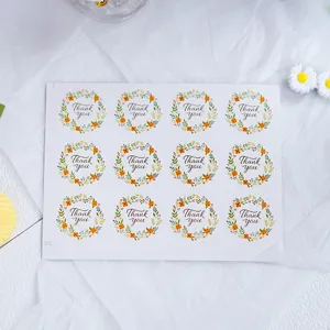 Hoja de pegatinas redondas de agradecimiento con diseño de corona de flores para embalaje