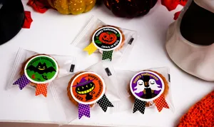 Halloween cookie gift bags with cute pumpkin bat ghost stickers, perfect for party favors and treats.