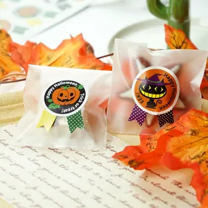 Halloween gift bag packaging and decorative stickers detail, featuring cute pumpkin and cat.