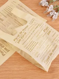 Detail view of plastic vest shopping bags with chic French letter prints for gift wrapping.