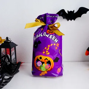 Halloween pumpkin ghost candy gift bag with gold ribbon, perfect for party favors and treats.