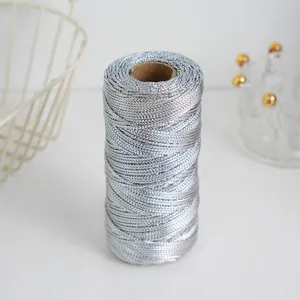 Detail view of metallic silver craft cord twine on spool, perfect for DIY gift wrapping and tags.