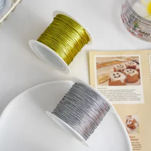 Gold and silver metallic thread close-up, perfect for DIY crafts, gift packaging and hang tags.