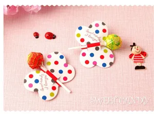 Cute butterfly lollipop paper cards for kids party, colorful polka dot DIY candy decoration.