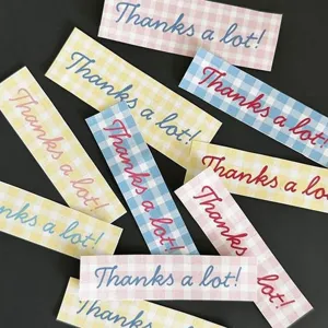 Closeup detail of decorative colorful grid stickers with thanks a lot text for diy journals.