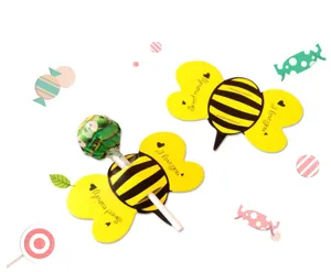Detailed view of cute cartoon bee lollipop paper cards with wings slot, sweet candy decor.