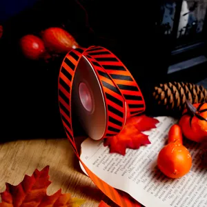 Halloween orange black striped ribbon roll for gift wrapping and DIY crafts decoration detail.