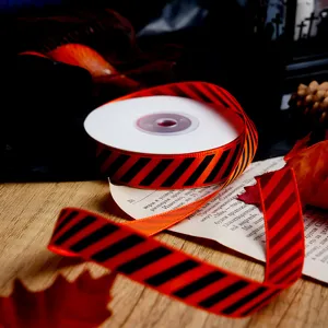 Orange and black diagonal stripe ribbon for Halloween DIY gift wrapping and holiday decor crafts.