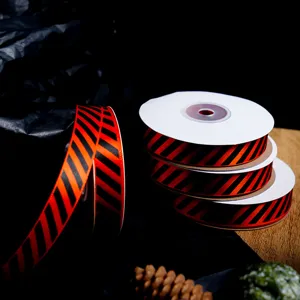 Halloween orange and black diagonal striped ribbon rolls for DIY gift wrapping and holiday decor.