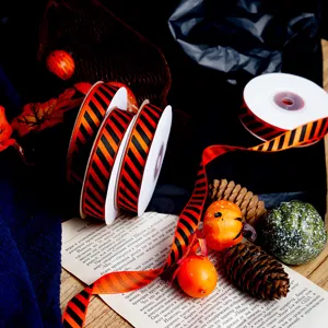 Halloween orange and black diagonal stripe ribbon rolls for DIY gift wrapping and decor.
