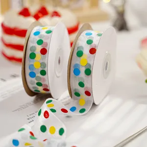 Colorful polka dot sheer ribbon close-up, perfect for gift wrapping, flower bouquet and party decor.