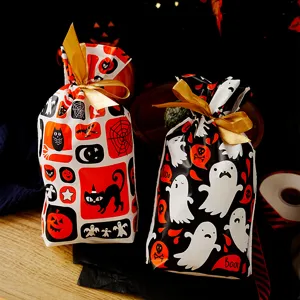 Halloween plastic candy gift bags with gold ribbons, cute ghost pumpkin print party favor bags.