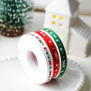 Closeup of Christmas grosgrain ribbon roll in red, white and green with merry christmas.
