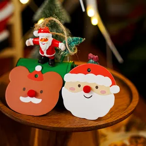 Detailed view of cute Christmas hanging tags and resin Santa ornaments, perfect for holiday decor.