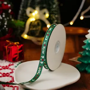 Green Christmas grosgrain ribbon roll, festive printed Merry Christmas gift wrapping ribbon detail