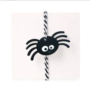 Close up of a cute black spider paper hang tag with black and white striped string for DIY.