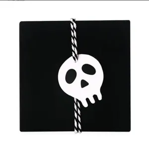 Detailed view showing black backing card with skull tag and cord for handmade DIY craft.