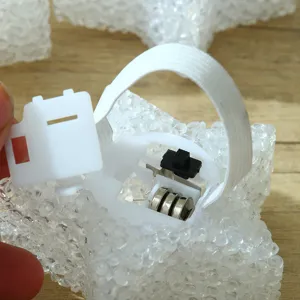 Detail view of the LED star light battery compartment showing button cells and elastic band.