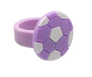 Detail shot of the cute purple and white football silicone ring, candy color party gift.