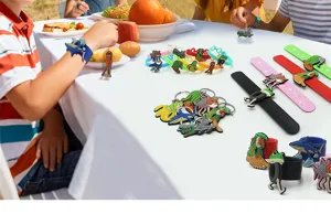 Detail view of quirky Classic of Mountains and Seas PVC keychains and slap bracelets.