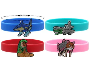 Set of 4 colorful silicone wristbands with funny abstract PVC charms, trendy novelty gifts.