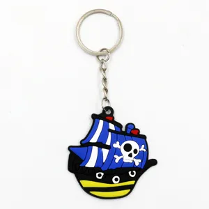 Close-up detail shot of a cute blue pirate ship keychain made of soft PVC with metal ring.