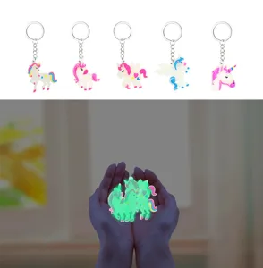 Detail view showcasing the luminous glow-in-the-dark effect and various cute unicorn keychains.
