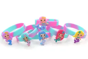 Mermaid silicone bracelet detail view, showing colorful bands and cute cartoon charms.