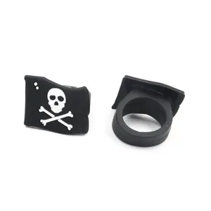 Detail shot of black silicone pirate skull ring, featuring clear white crossbones flag motif.