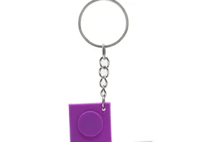 Detail shot of purple PVC building block game controller keychain, metal ring and chain.