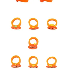 Close-up details of kids Halloween pumpkin rings, made of soft PVC in bright orange color.