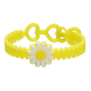 Gros plan détaillé du bracelet mignon en silicone marguerite jaune avec des trous en cœur.