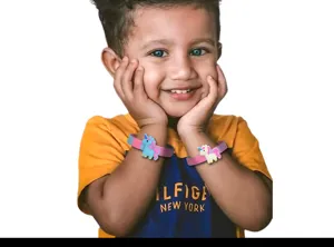 Closeup of cute silicone unicorn wristbands worn by a child, featuring soft PVC charms.